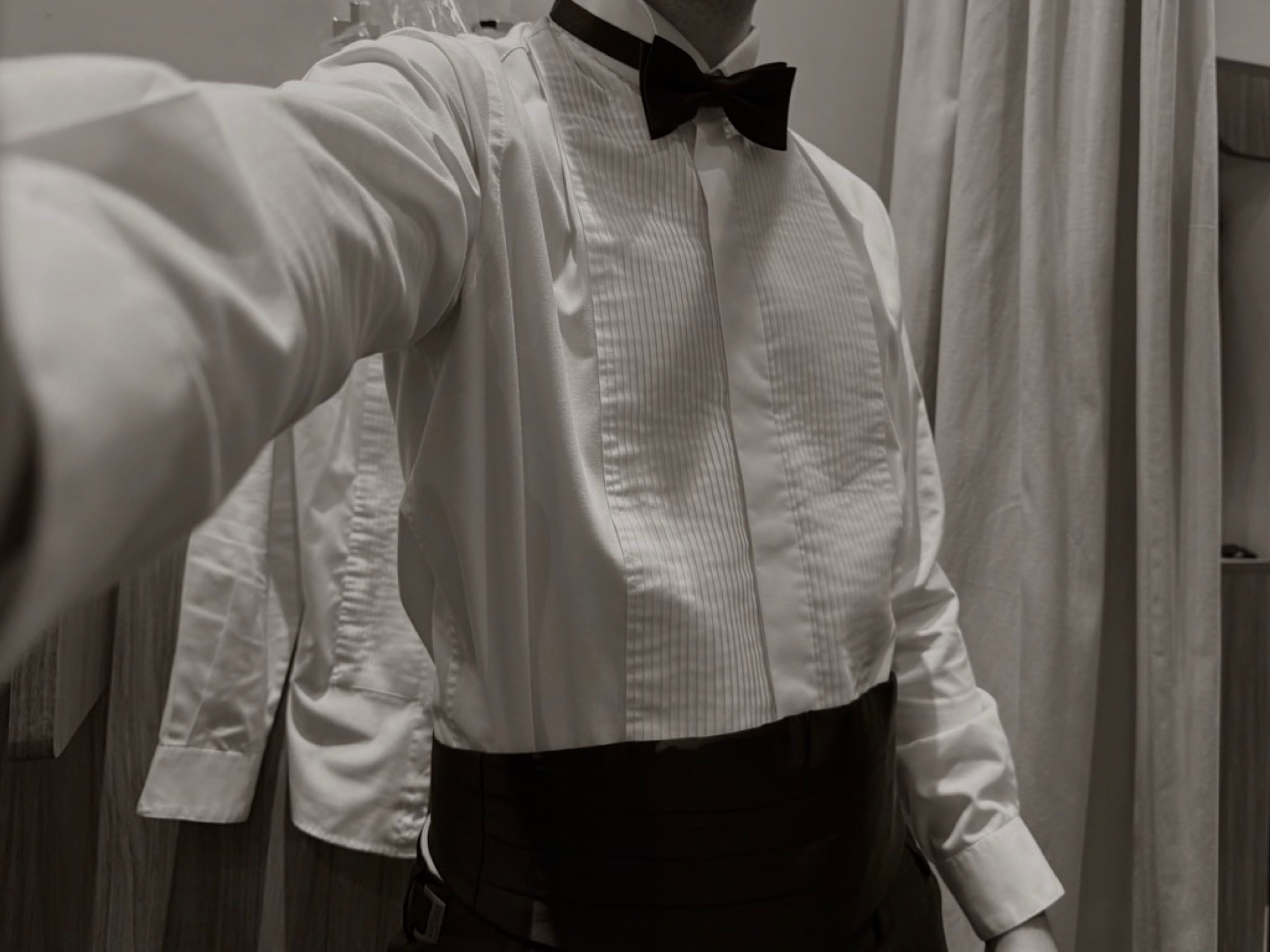 Mirror selfie in a tuxedo shirt and bow tie